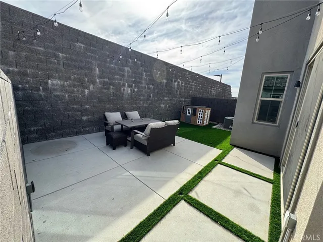 an aerial view of residential houses with outdoor space and ocean view