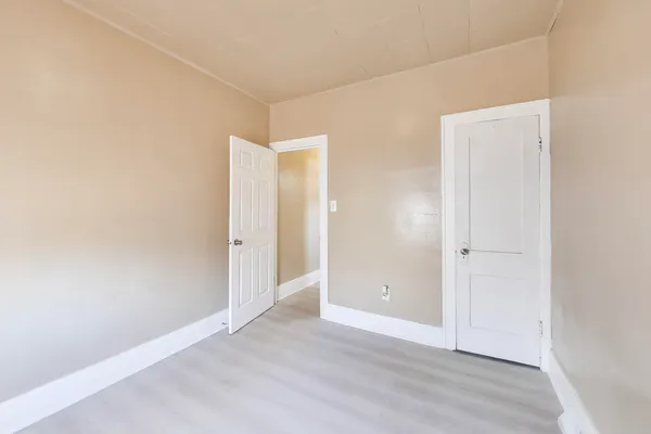 an empty room with wooden floor