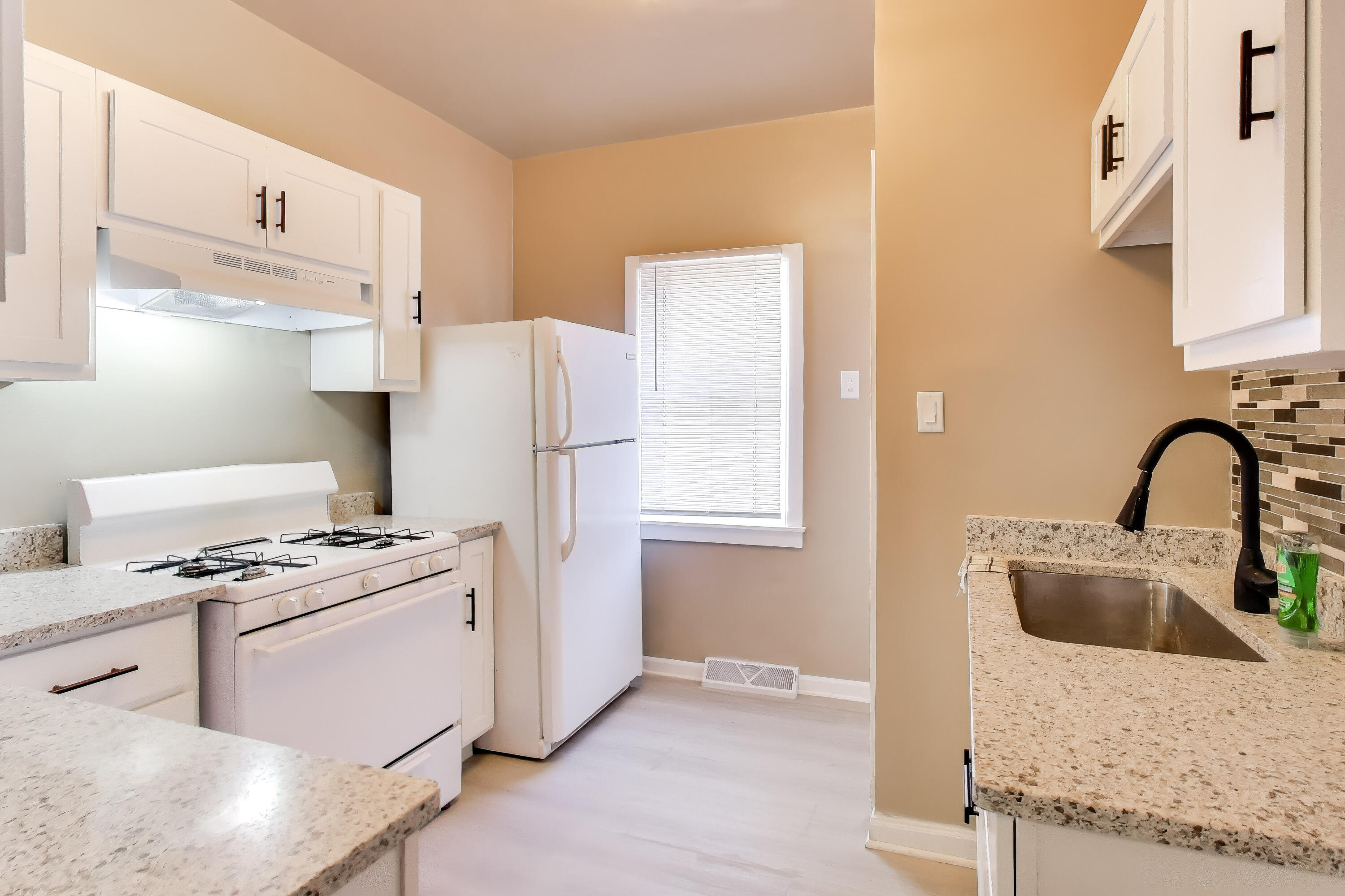 329 Pierce Street Gary, IN 46402 - Photo 8 of 17 a kitchen with a stove a refrigerator and cabinets