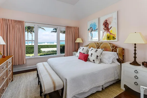 a bedroom with a bed a couch and a window