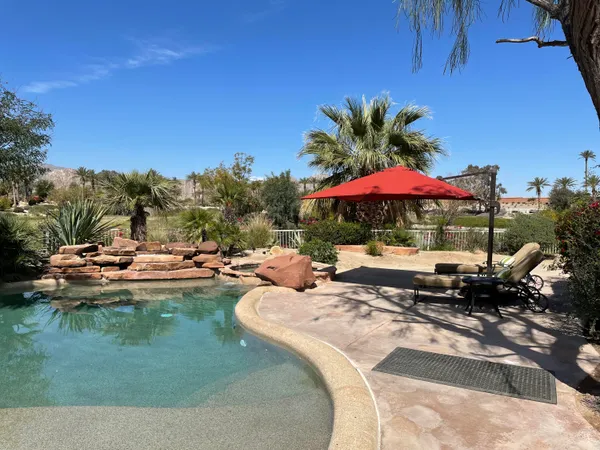 a view of swimming pool with outdoor seating