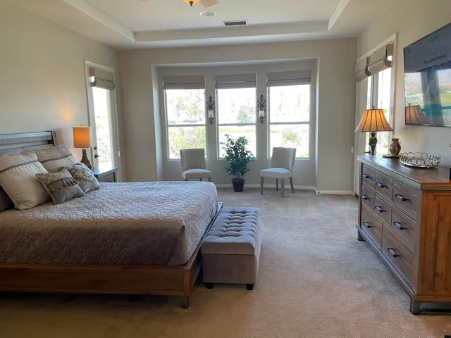 a spacious bedroom with a bed and a couch