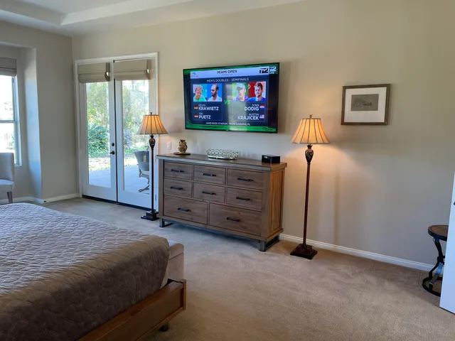 a bed room with a bed and a television