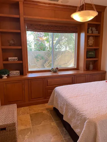 a bedroom with a bed and a window