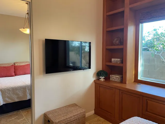 a large bed sitting in a bedroom with a lamp