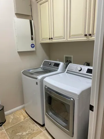 a large bed sitting in a bedroom next to a lamp