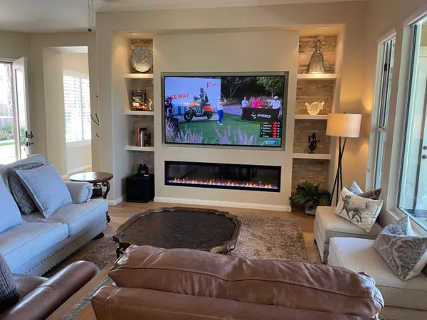 a living room with furniture and a fireplace