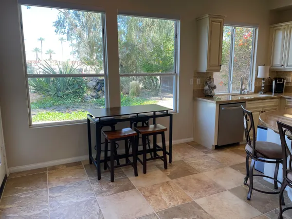 a view of a dining room with furniture window and outside view