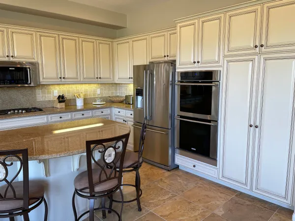 a kitchen with stainless steel appliances a refrigerator sink and cabinets