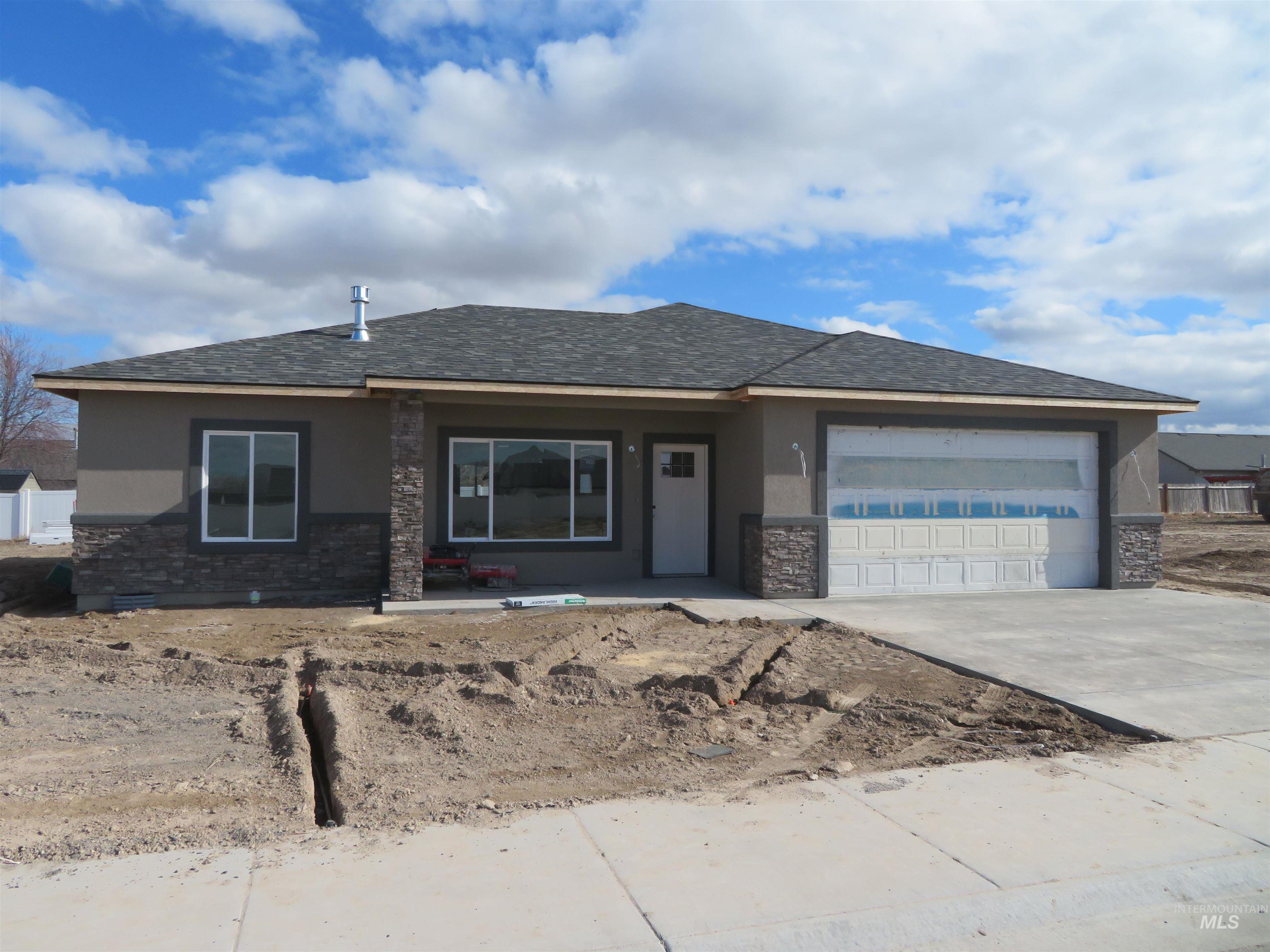 View of front of home featuring stucco siding, stone siding, concrete driveway, roof with shingles, and an attached garage
