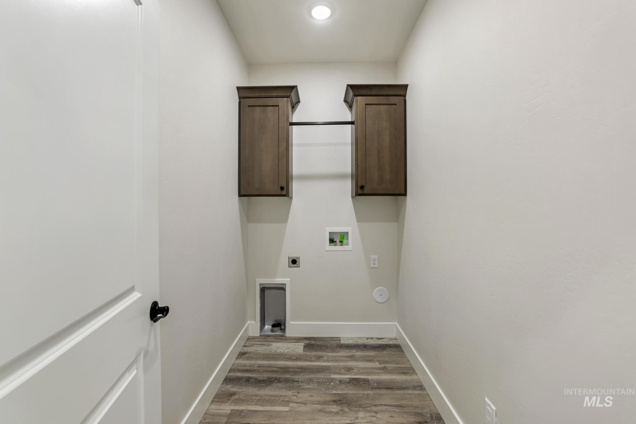 1413 Haizlee Way Twin Falls, ID 83301 - Photo 11 of 28 Laundry area with cabinet space, light wood-style floors, electric dryer hookup, hookup for a washing machine, and recessed lighting