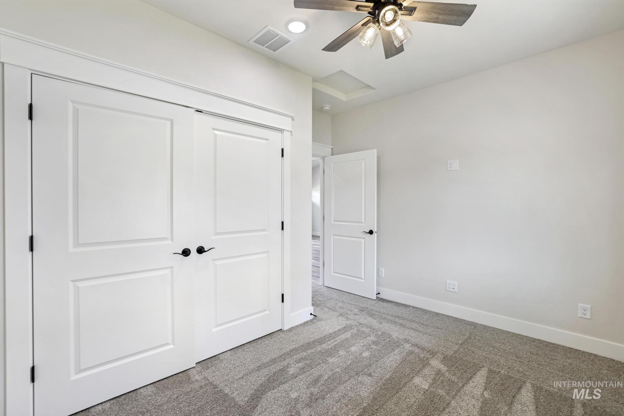 1413 Haizlee Way Twin Falls, ID 83301 - Photo 21 of 28 Unfurnished bedroom featuring attic access, carpet, a closet, ceiling fan, and recessed lighting