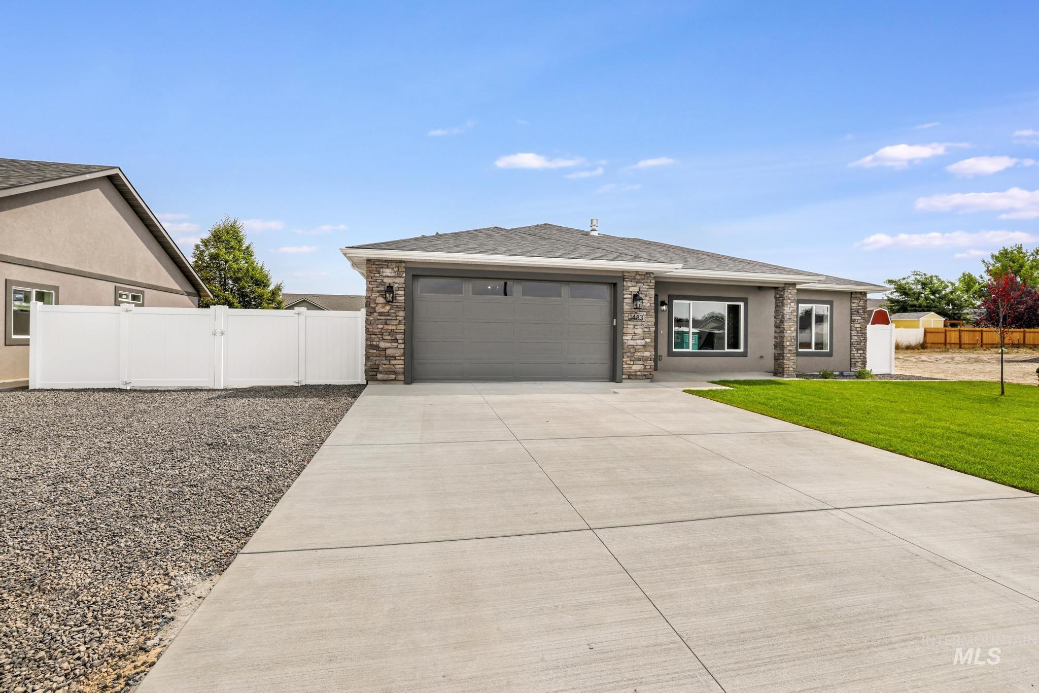 1413 Haizlee Way Twin Falls, ID 83301 - Photo 25 of 28 View of front of property featuring concrete driveway, a gate, a garage, roof with shingles, and stucco siding