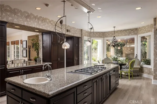 a bathroom with a granite countertop sink a large mirror and a shower