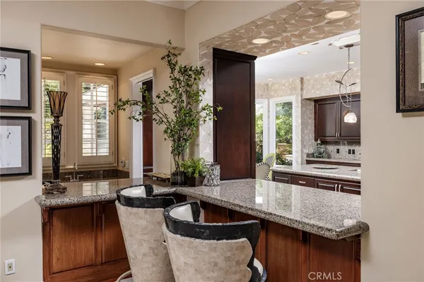 a kitchen with granite countertop a sink and a stove