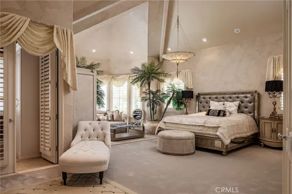 a spacious bedroom with a bed and large windows