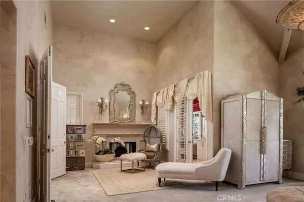 a living room with furniture a large window and a fireplace