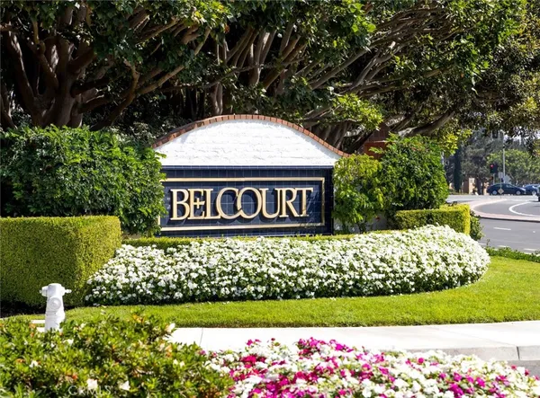 a sign that is sitting in front of flowers