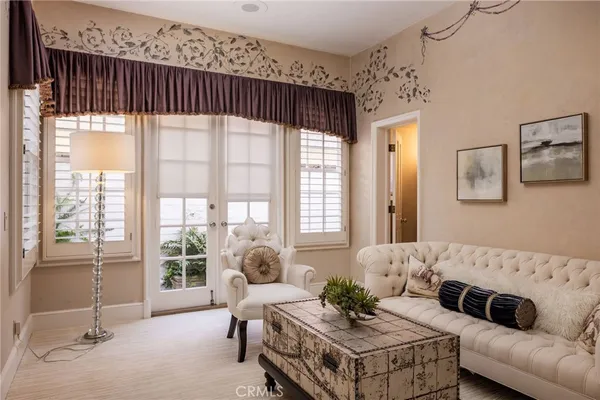 a living room with furniture a flat screen tv and potted plant
