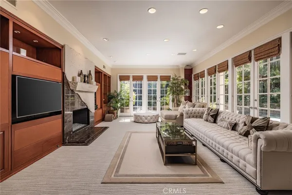 a living room with furniture large windows and a flat screen tv