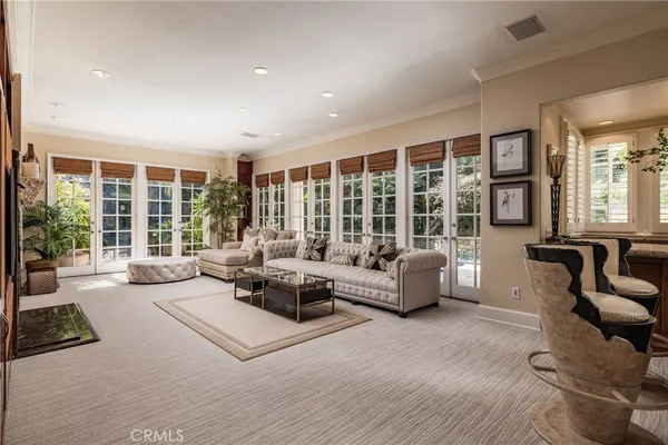 a living room with furniture and large windows