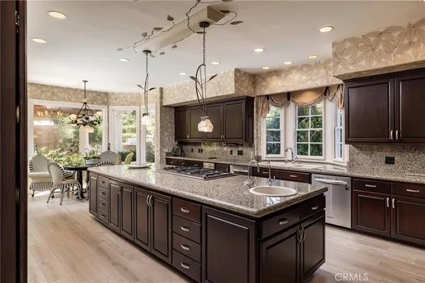 a kitchen with a stove sink and cabinets