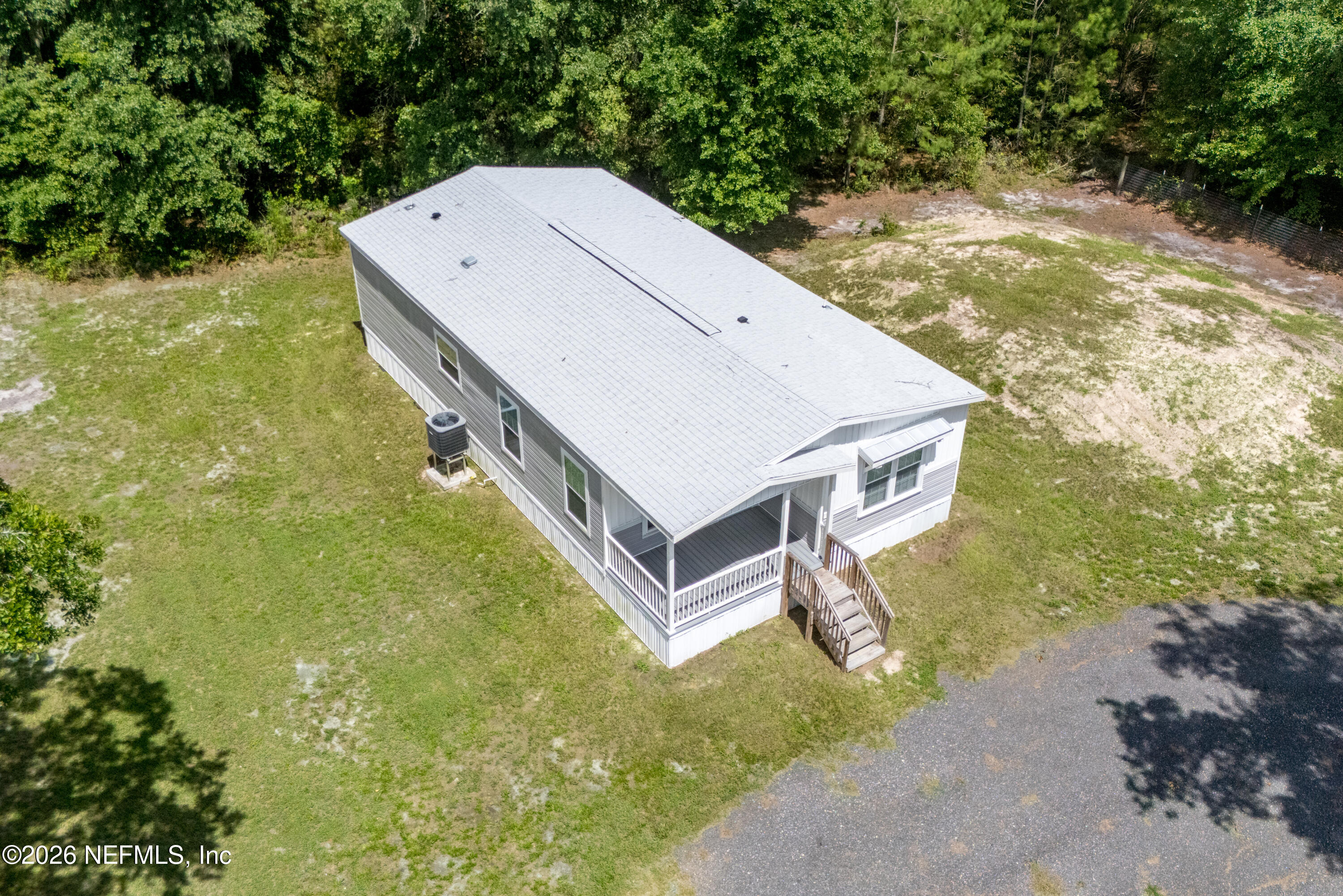 15049 Southwest 75th Avenue Starke, FL 32091 - Photo 16 of 64 a view of a small house in the background with a trees