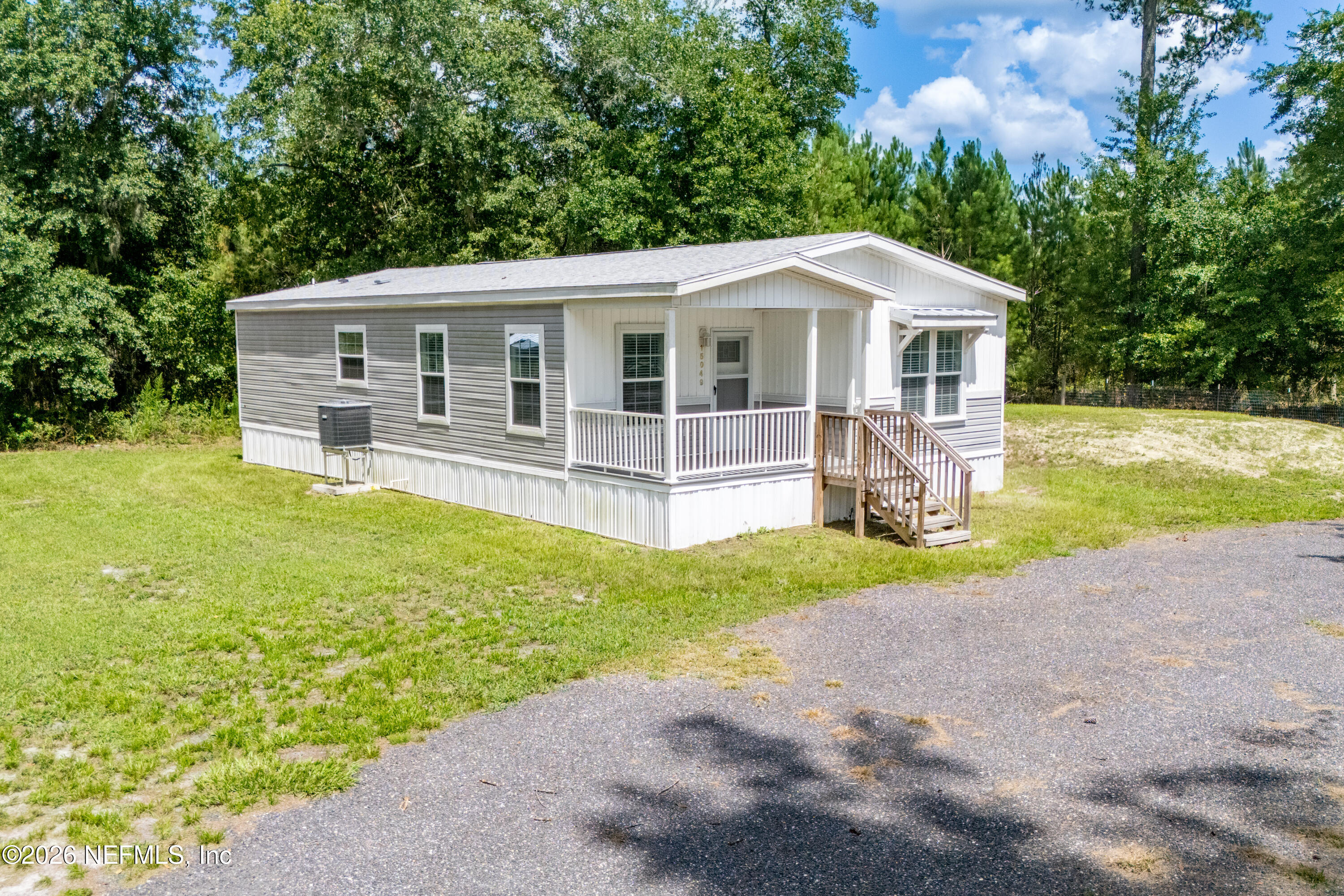 15049 Southwest 75th Avenue Starke, FL 32091 - Photo 19 of 64 a front view of a house with yard and green space