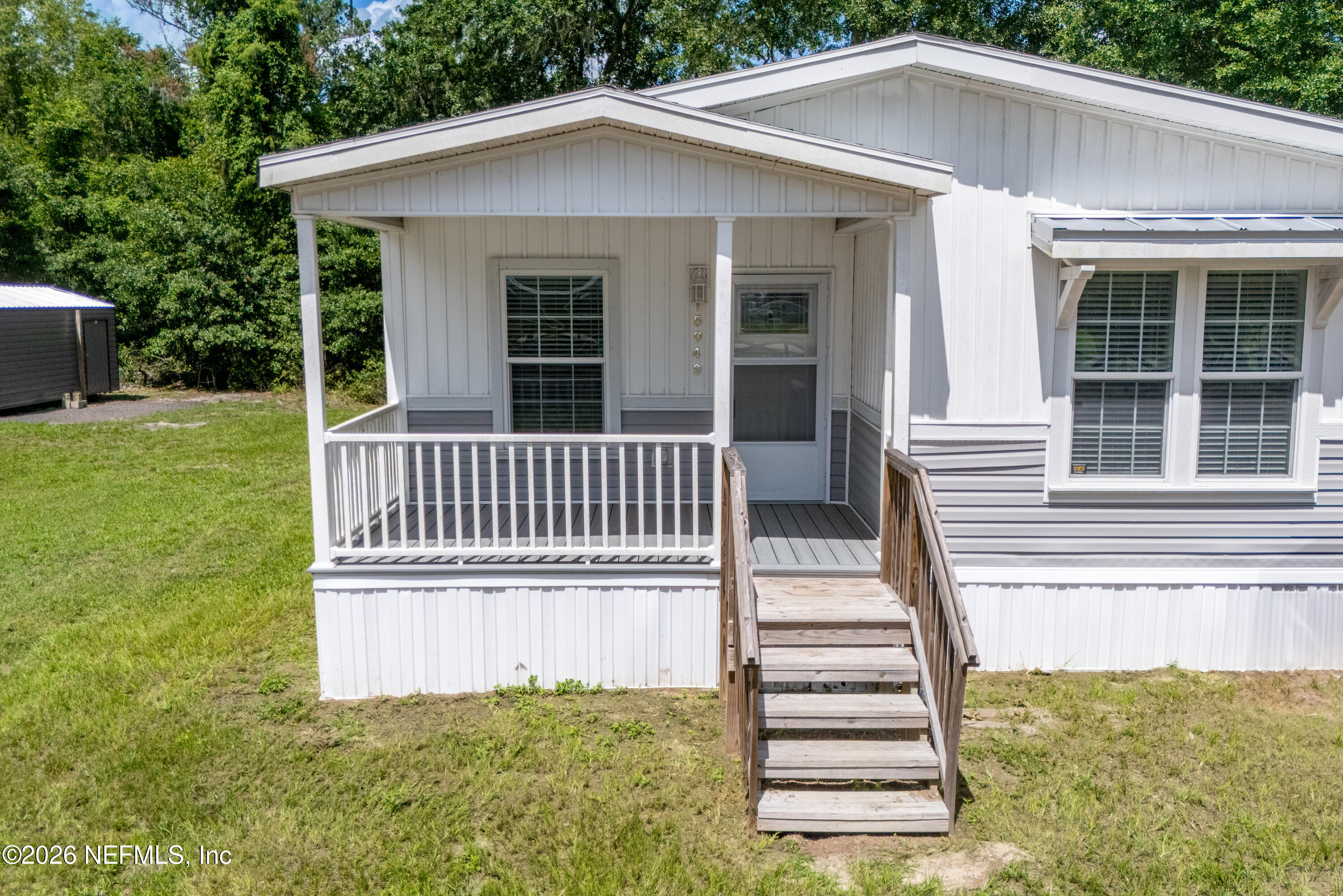 15049 Southwest 75th Avenue Starke, FL 32091 - Photo 23 of 64 a view of a house with a yard and deck
