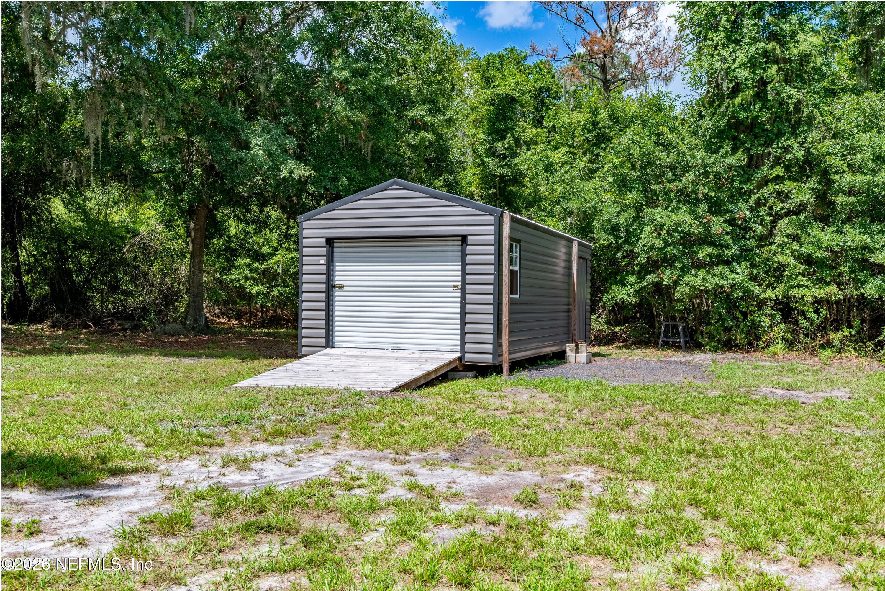 15049 Southwest 75th Avenue Starke, FL 32091 - Photo 26 of 64 a front view of a house with yard and green space