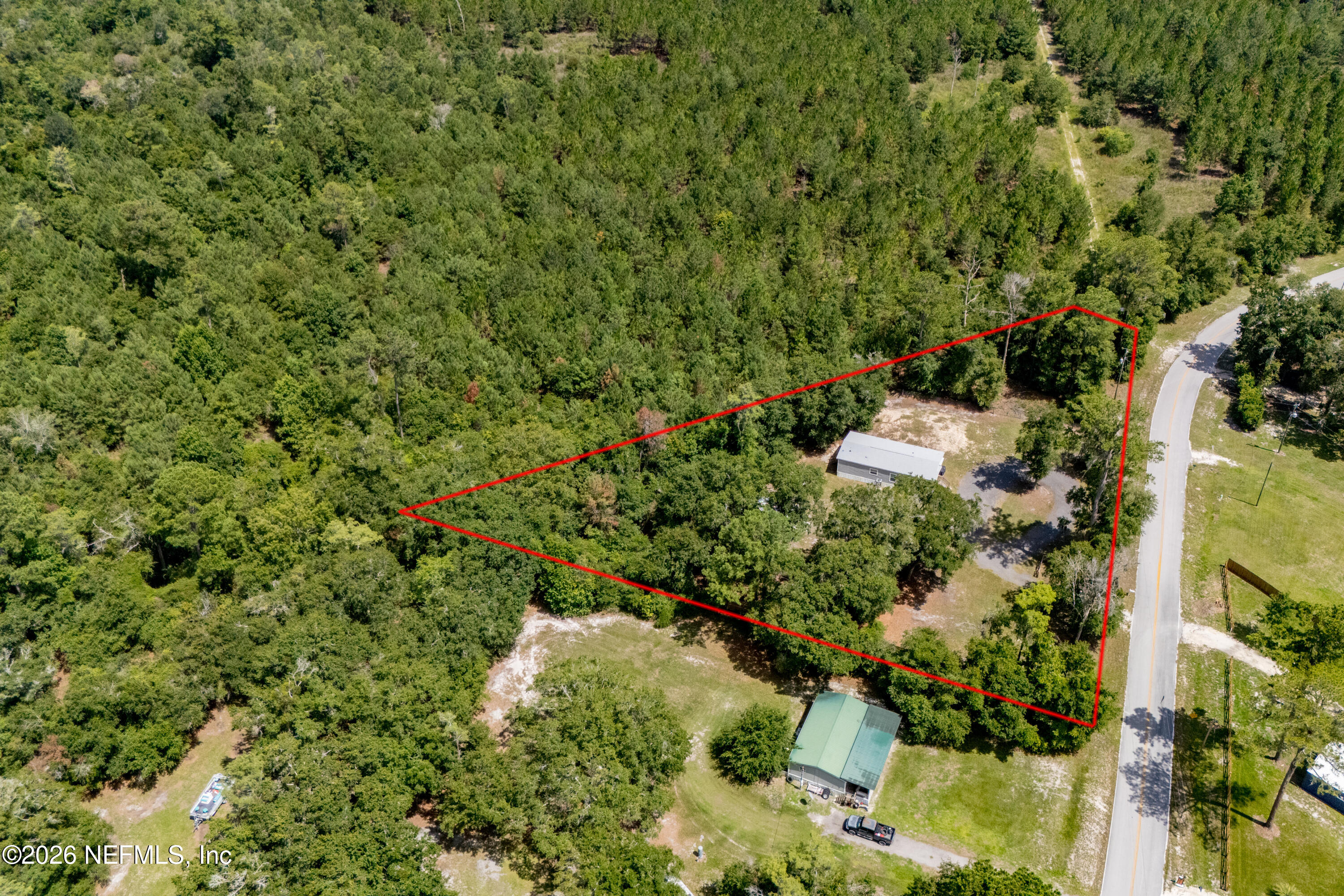 15049 Southwest 75th Avenue Starke, FL 32091 - Photo 34 of 64 an aerial view of residential house with outdoor space and trees all around