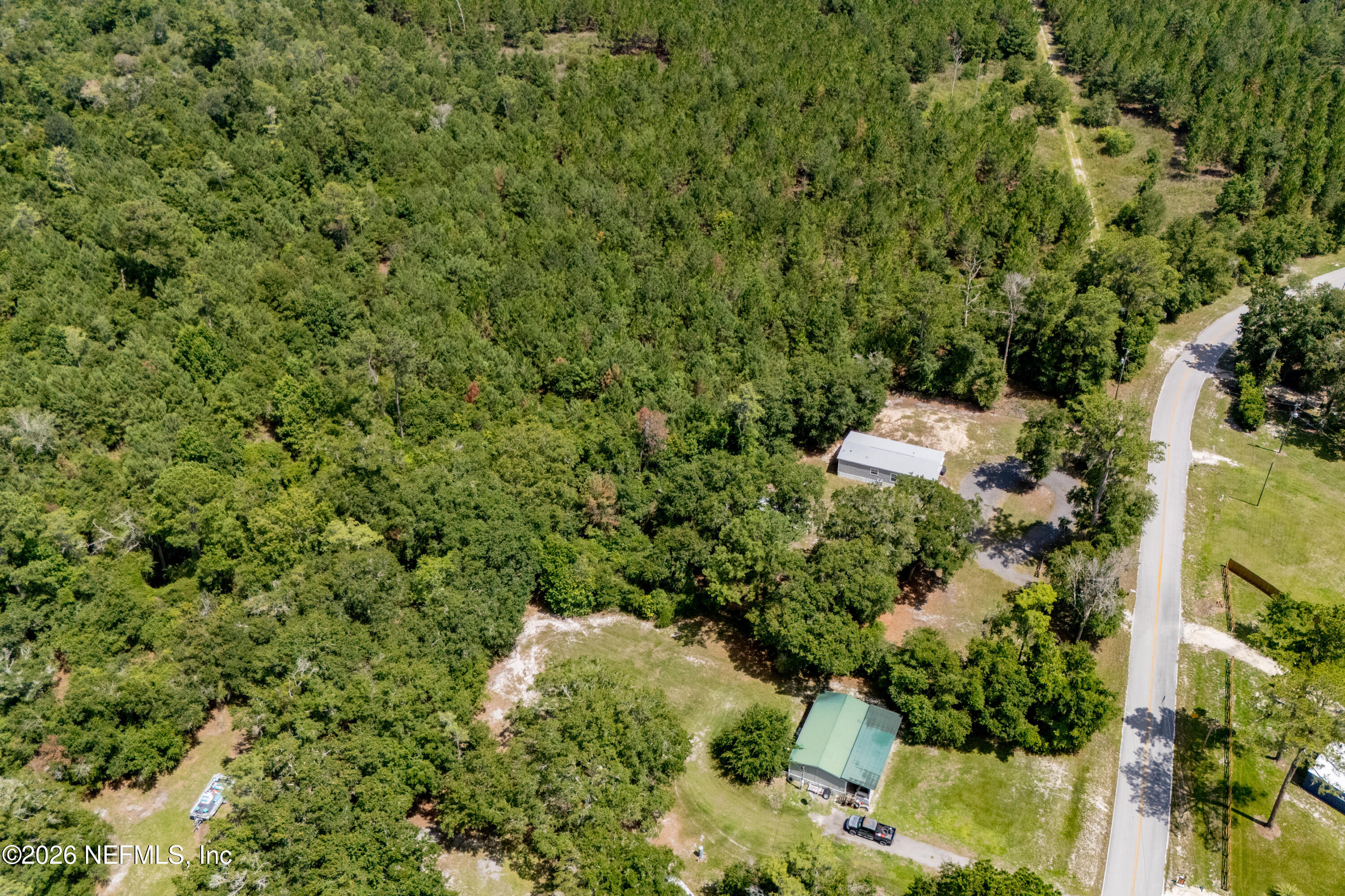 15049 Southwest 75th Avenue Starke, FL 32091 - Photo 35 of 64 an aerial view of residential house with outdoor space and trees all around