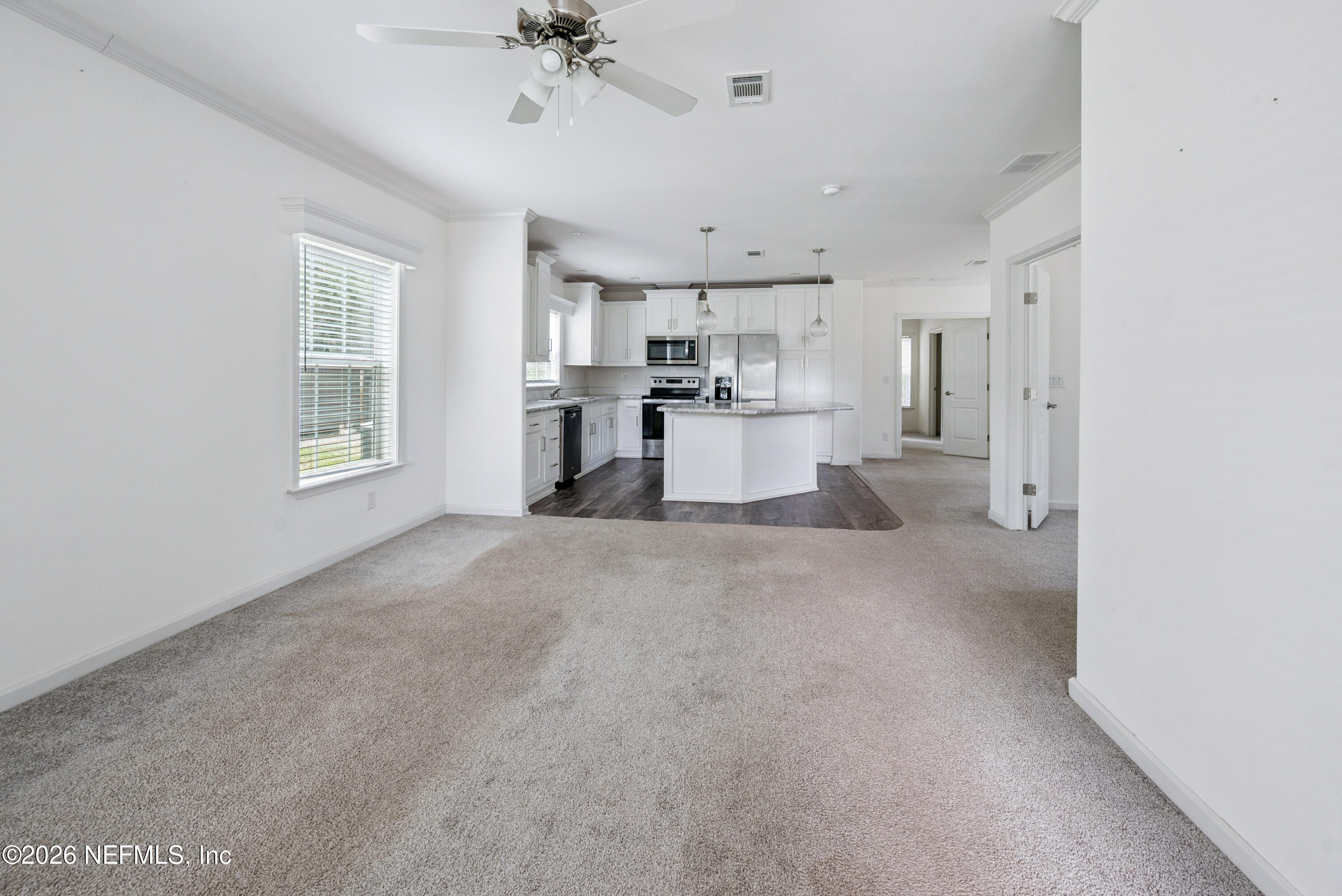 15049 Southwest 75th Avenue Starke, FL 32091 - Photo 36 of 64 a view of a kitchen with furniture and a ceiling fan