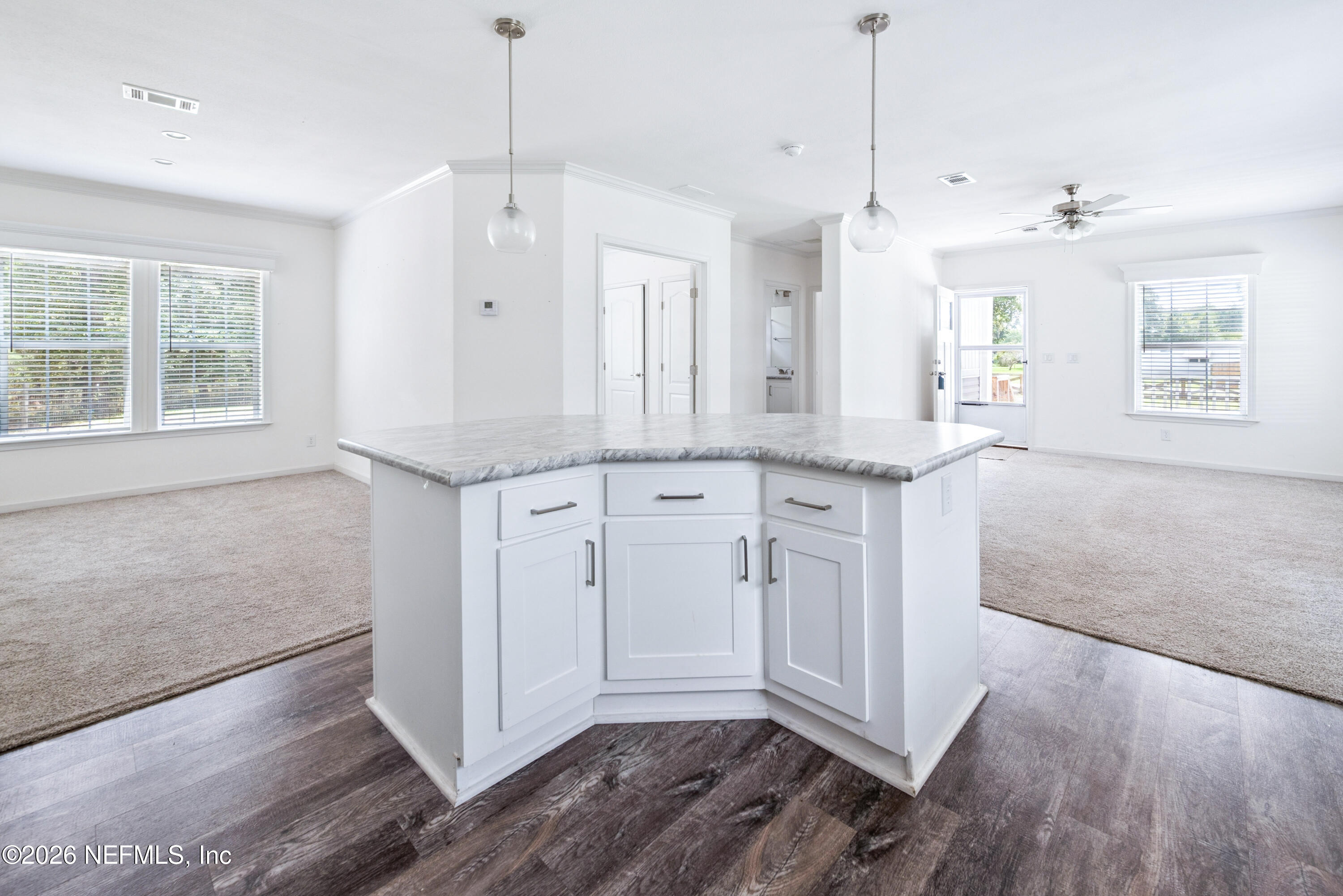 15049 Southwest 75th Avenue Starke, FL 32091 - Photo 47 of 64 a open kitchen with white cabinets and wooden floor