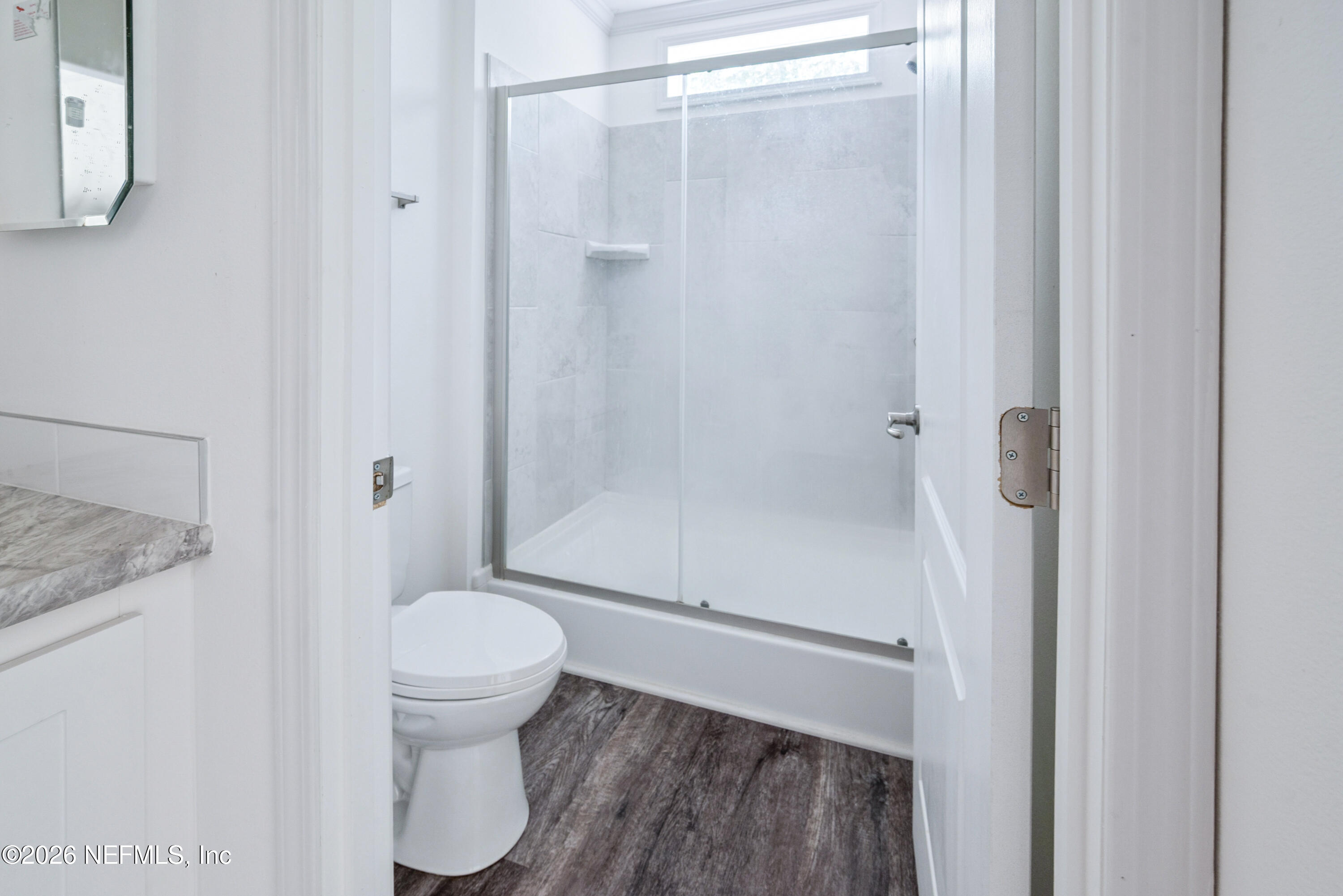 15049 Southwest 75th Avenue Starke, FL 32091 - Photo 62 of 64 a bathroom with a granite countertop toilet and a shower
