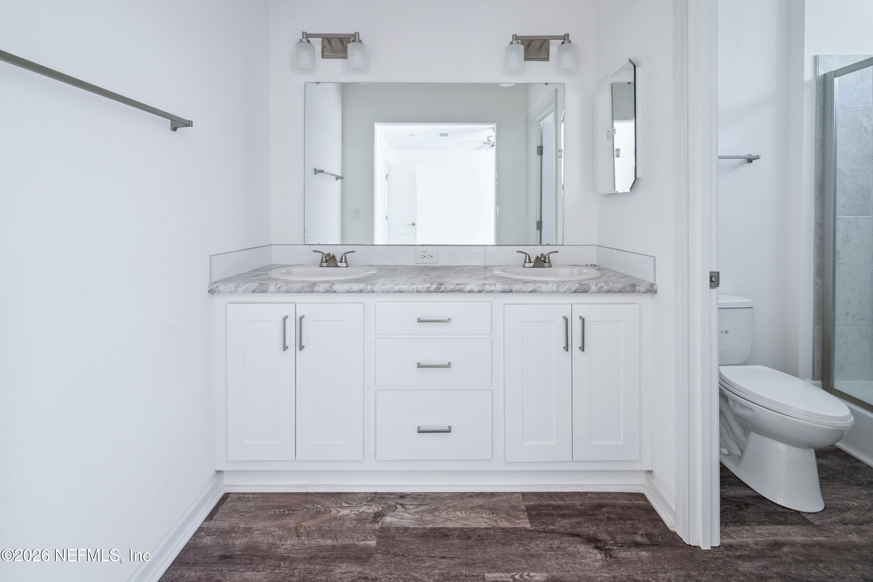 15049 Southwest 75th Avenue Starke, FL 32091 - Photo 63 of 64 a bathroom with a granite countertop sink and a toilet