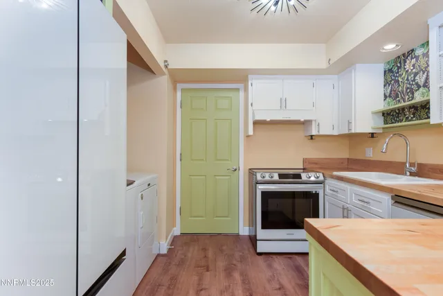 a kitchen with a sink and a stove top oven