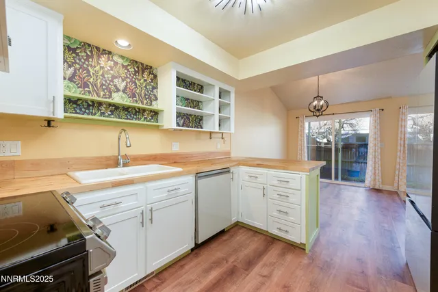 a kitchen with cabinets wooden floor and a sink