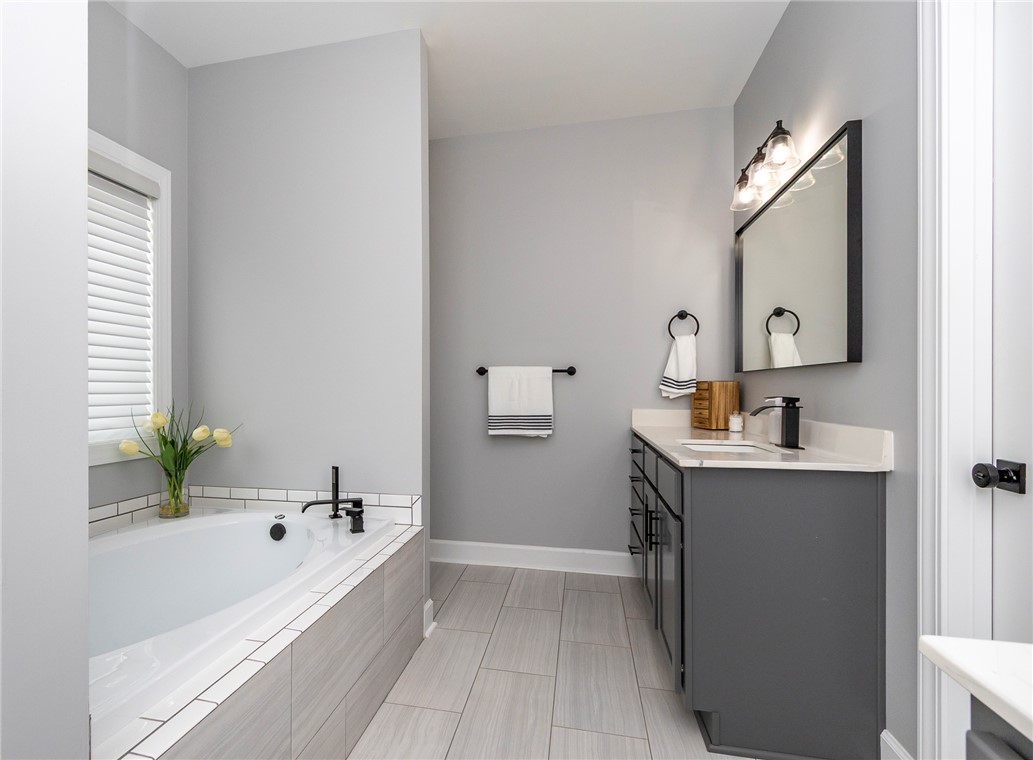 3080 McGee Road Iva, SC 29655 - Photo 33 of 49 This primary bathroom showcases an inviting soaking tub and a chic vanity.
