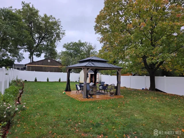 a view of a patio with table and chairs under an umbrella