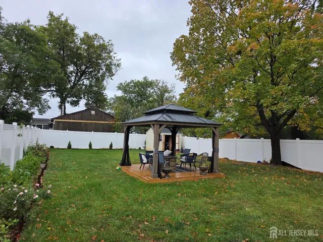 a view of a patio with a table and chairs under an umbrella