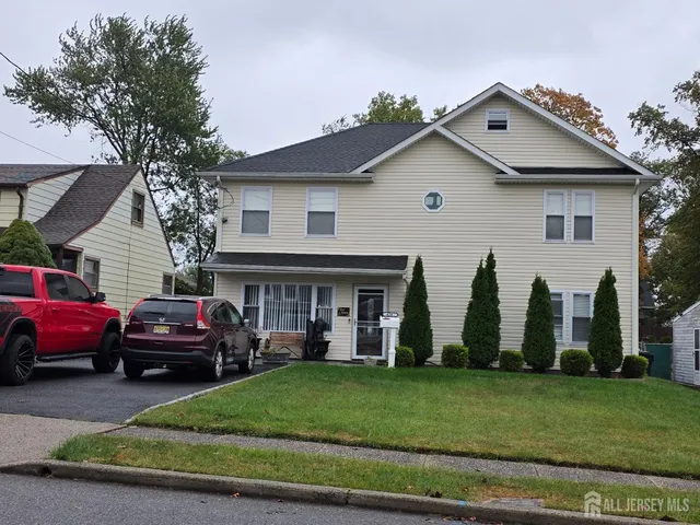 a front view of a house with a garden and plants