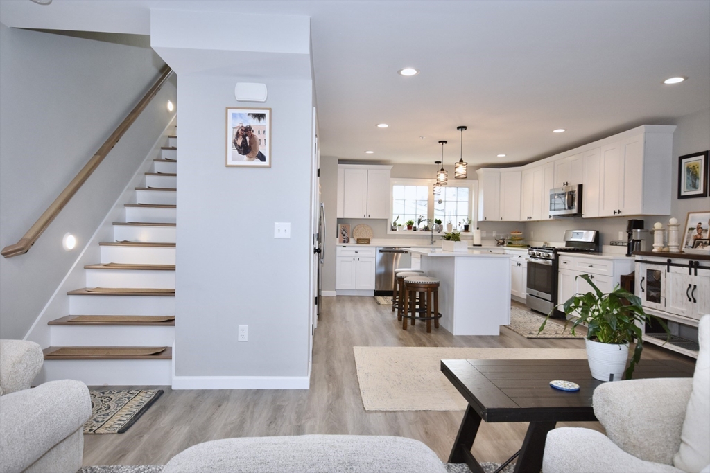 550 Spring Street, Unit 2 Fall River, MA 02721 - Photo 7 of 13 a living room with stainless steel appliances kitchen island granite countertop furniture and a kitchen view