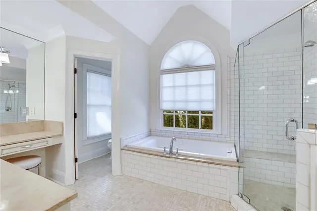 a bathroom with a bathtub sink and mirror