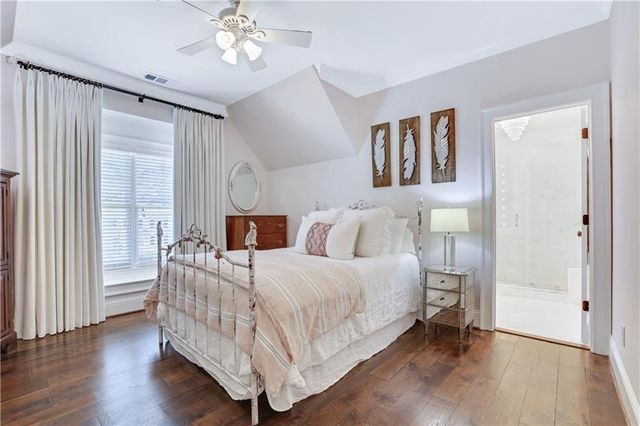 a bathroom with a shower sink mirror and toilet