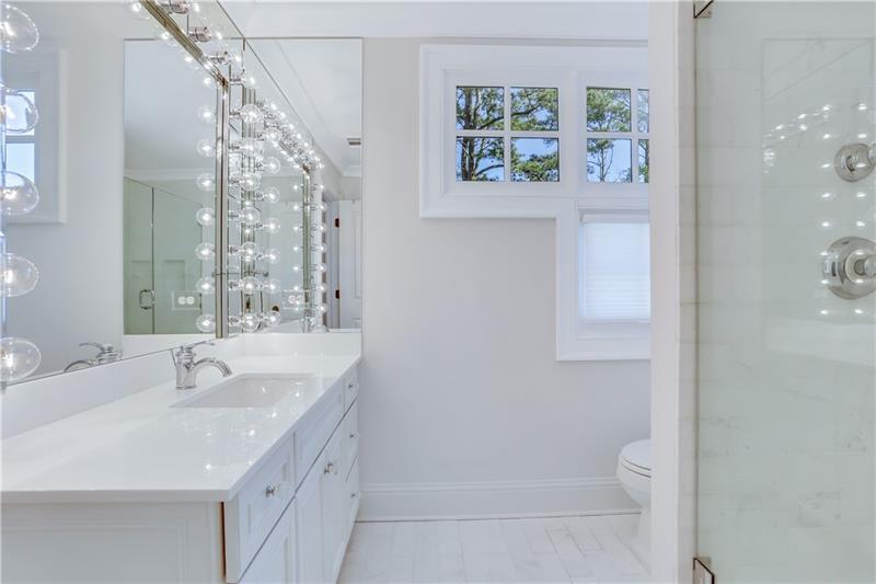3100 Rhodenhaven Drive Northwest Atlanta, GA 30327 - Photo 33 of 52 a bathroom with a sink a toilet and a large mirror
