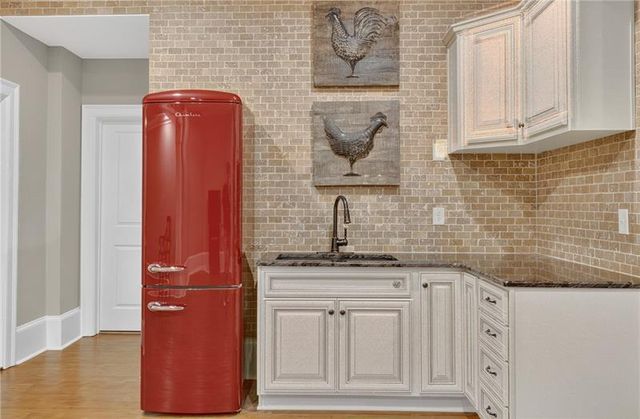 a room with gym equipment and a chandelier