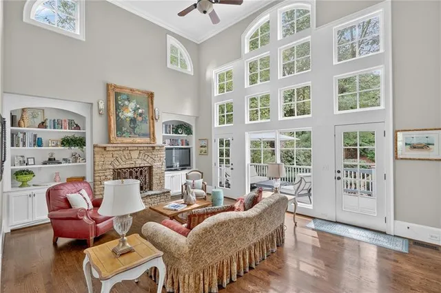a living room with furniture a fireplace and a window