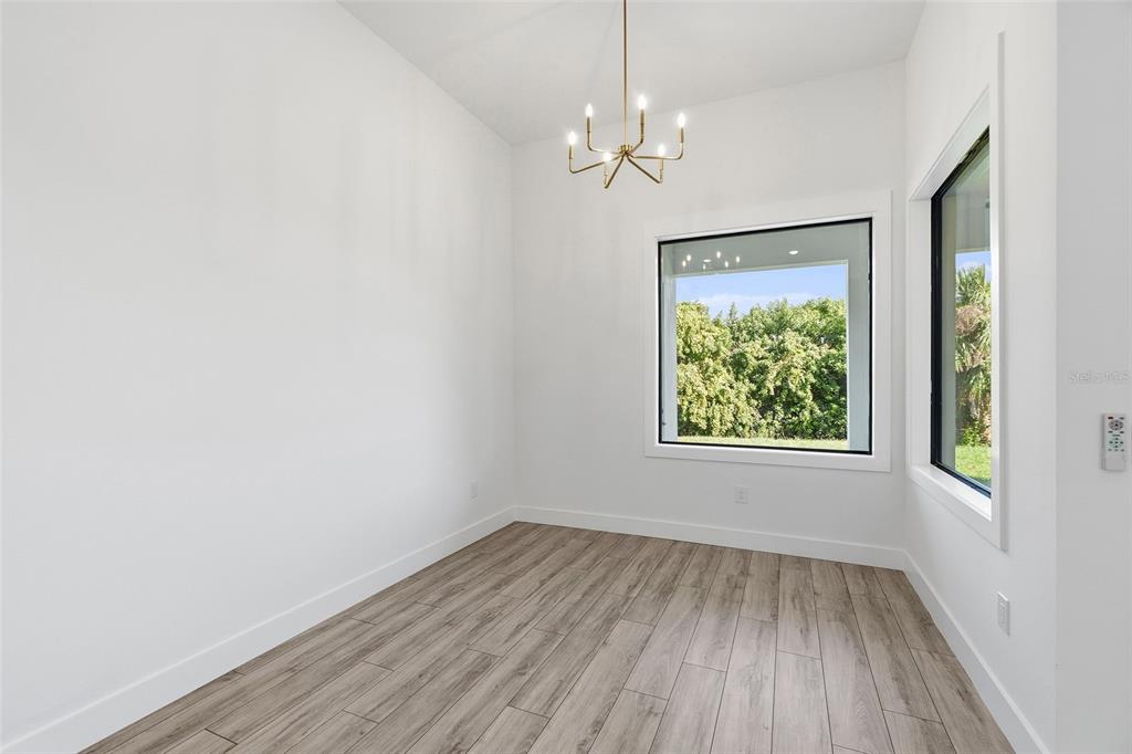 210 Tournament Road Rotonda West, FL 33947 - Photo 11 of 59 an empty room that has a window