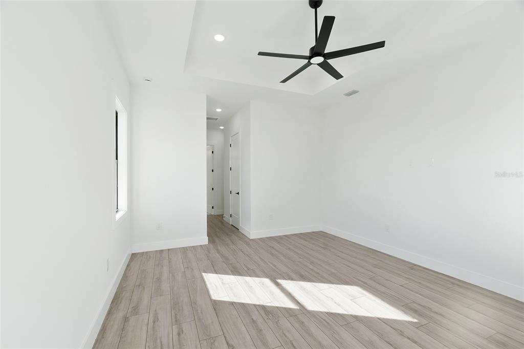 210 Tournament Road Rotonda West, FL 33947 - Photo 15 of 59 a view of a room with wooden floor and white walls